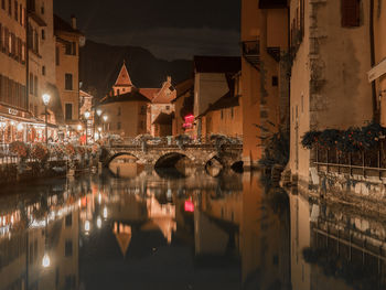 Reflection of illuminated buildings in city at night