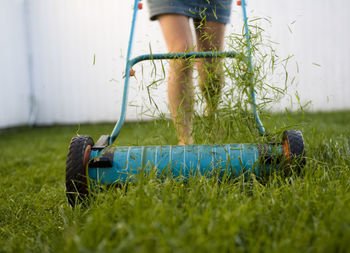 Woman mowing lawn