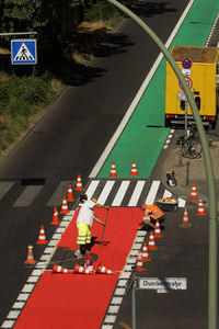 High angle view of people crossing sign on road