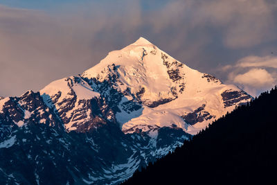 Scenic view of snowcapped mountains against sky during winter