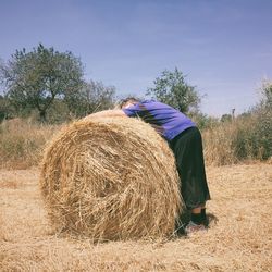 Full length of man in field against clear blue sky