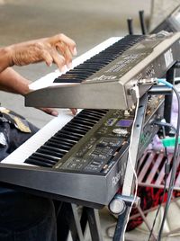 Close-up of man playing piano