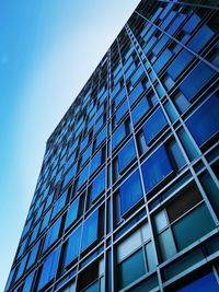 Low angle view of modern building against clear blue sky