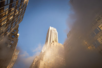 Low angle view of clouds and buildings