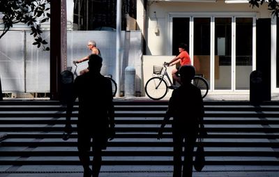 Rear view of people walking on staircase