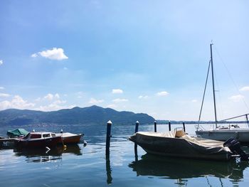 Boats moored on sea against sky