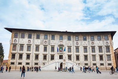 Tourists and locals at the palazzo della carovana built in 1564 located at knights square in pisa