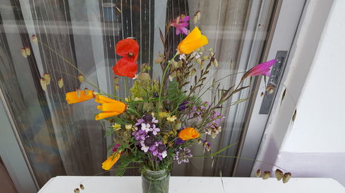 Flowers growing on window sill