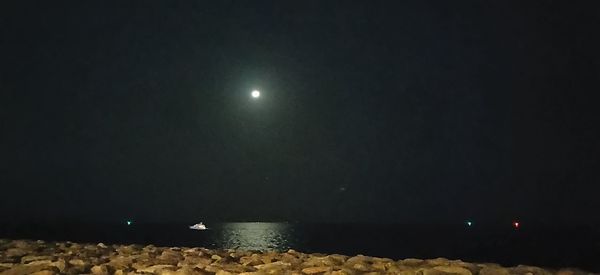 Scenic view of moon against clear sky at night