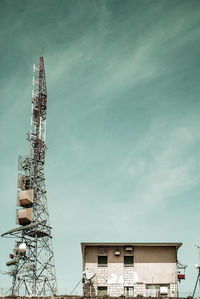 Low angle view of communications tower against sky