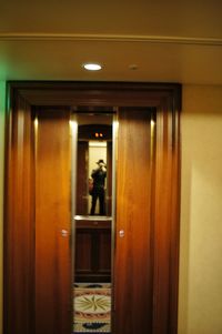 Reflection of man on glass door