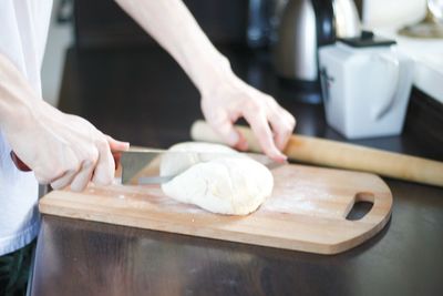 Midsection of man preparing food in kitchen