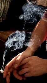 Close-up of hands against black background