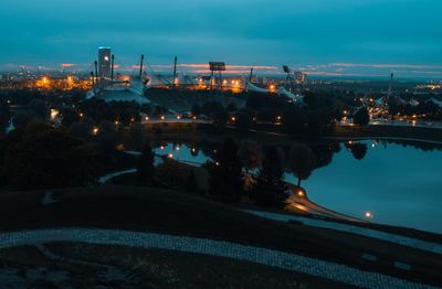 Illuminated city against sky at dusk