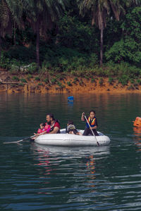 People in boat on lake