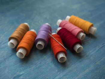 Close-up of sewing items on wooden table