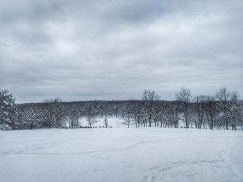 Scenic view of snow covered field against sky