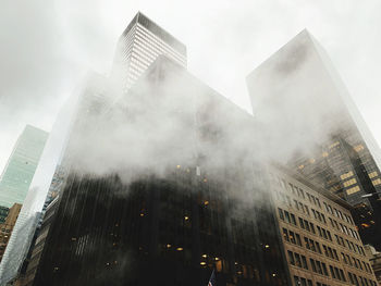 Low angle view of modern buildings against sky in city