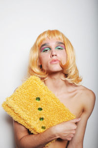 Portrait of woman with yellow hair against white background