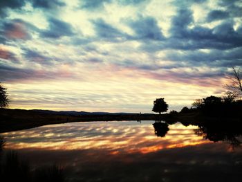 Scenic view of lake against orange sky