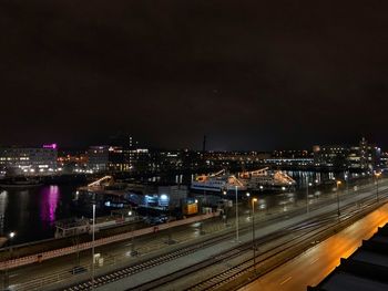 High angle view of illuminated buildings against sky at night