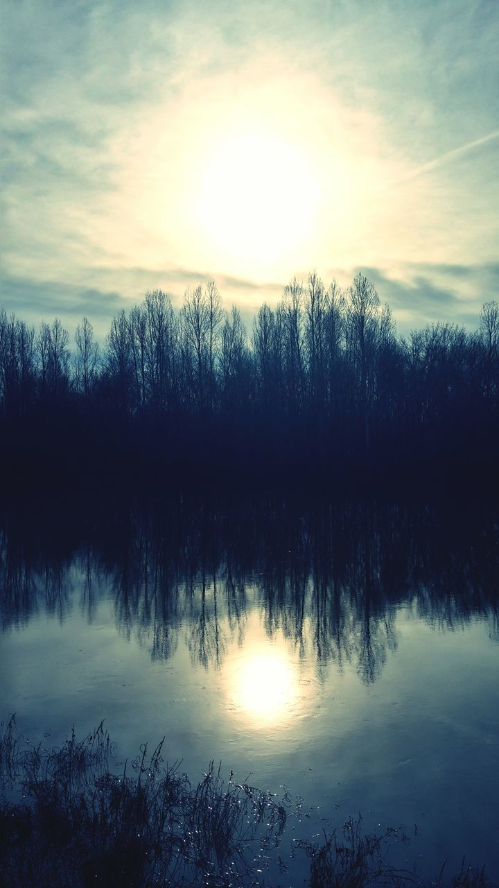 reflection, water, tranquil scene, lake, tranquility, scenics, tree, sky, beauty in nature, sunset, sun, nature, silhouette, cloud - sky, idyllic, waterfront, sunlight, cloud, outdoors, bare tree