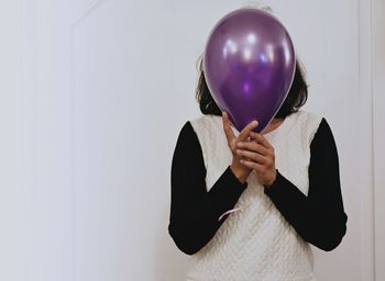 Midsection of woman holding balloons