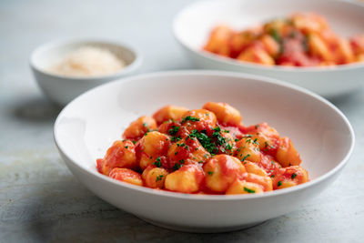 Gnocchi with tomato sauce and parmigiano on a plate