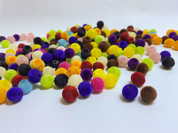 Close-up of multi colored candies against white background