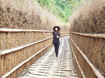 Full length of woman standing on footpath