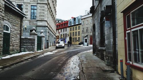 Road amidst buildings in city