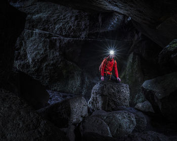 Man with headlamp exploring cave