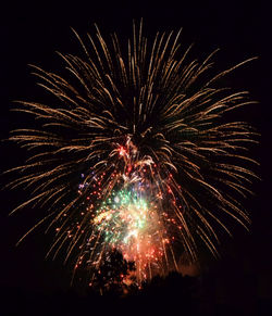 Low angle view of firework display against sky at night