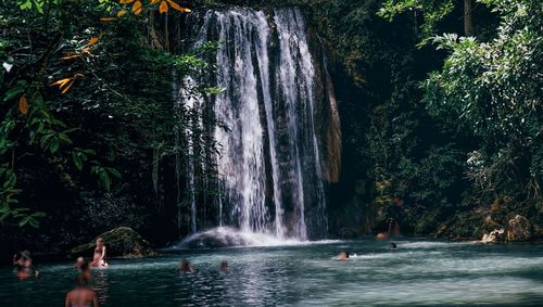 Scenic view of waterfall against trees