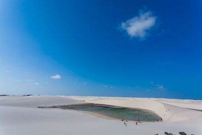 Scenic view of beach against blue sky