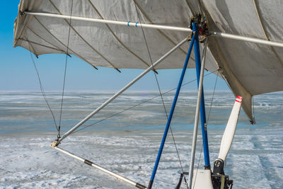 White sport hang glider on an ice field	