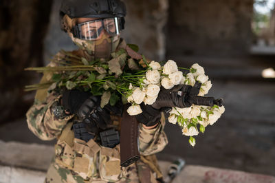 Rear view of army soldier with bouquet