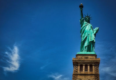 Low angle view of statue against blue sky