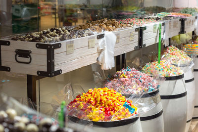 Colorful fragrant sweets in huge barrels in the store.