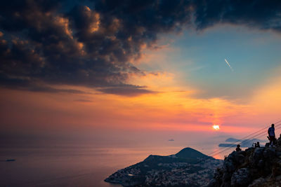 Scenic view of mountains against orange sky