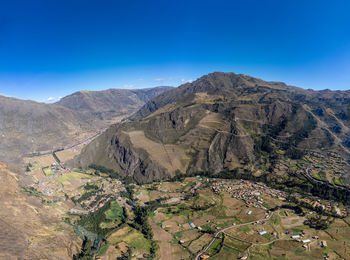 Scenic view of mountains against clear blue sky