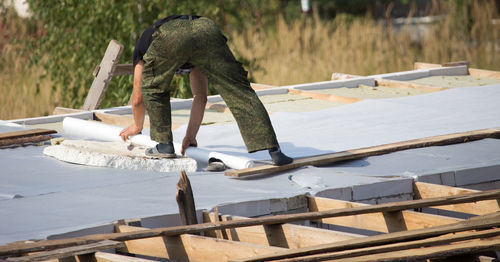 Man working on wood in water