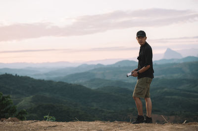 Full length of man standing on mountain