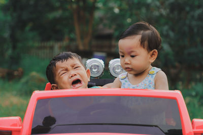Portrait of cute boy and daughter outdoors
