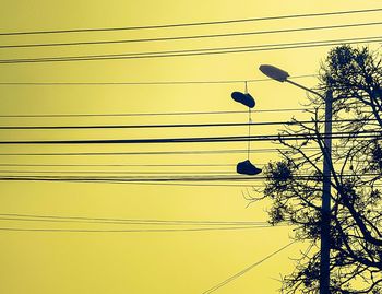 Low angle view of birds perching on power line