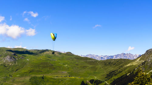 Hot air balloon flying over mountain