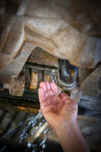 Close-up of hand under running water