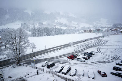 High angle view of cars on snow covered field