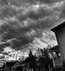 Low angle view of buildings against cloudy sky