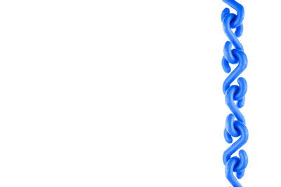 Close-up of blue plastic chain against white background